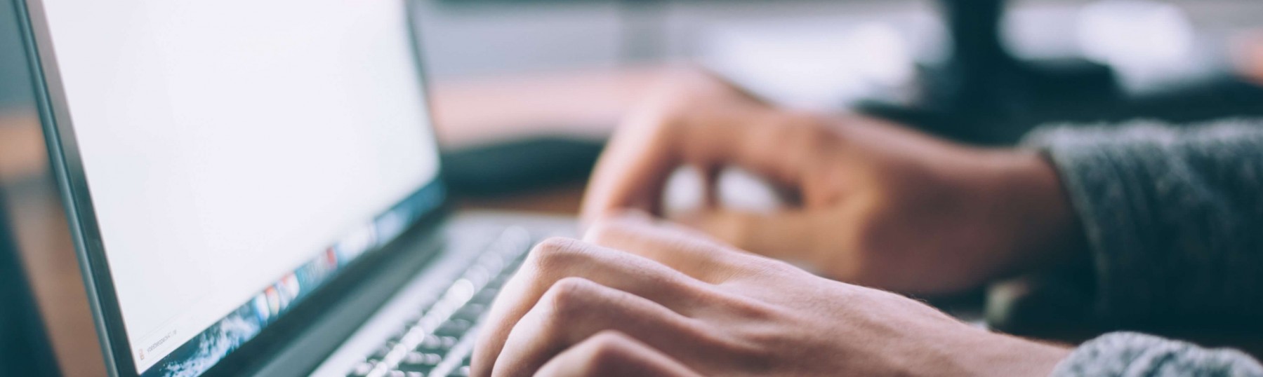 Close up of a person typing on a computer