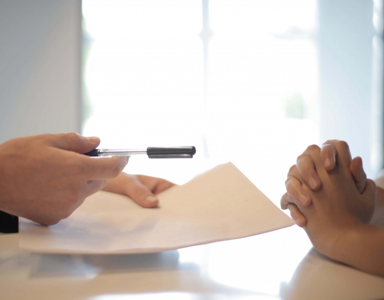 man passing contract to woman