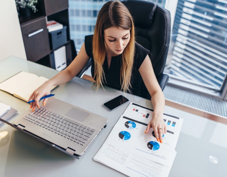 woman at a desk looking at paperwork