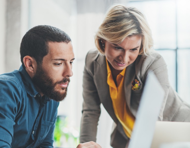 two people looking at a computer