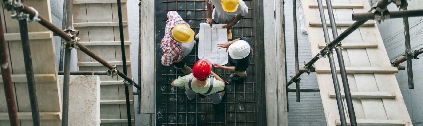 four people on a construction site