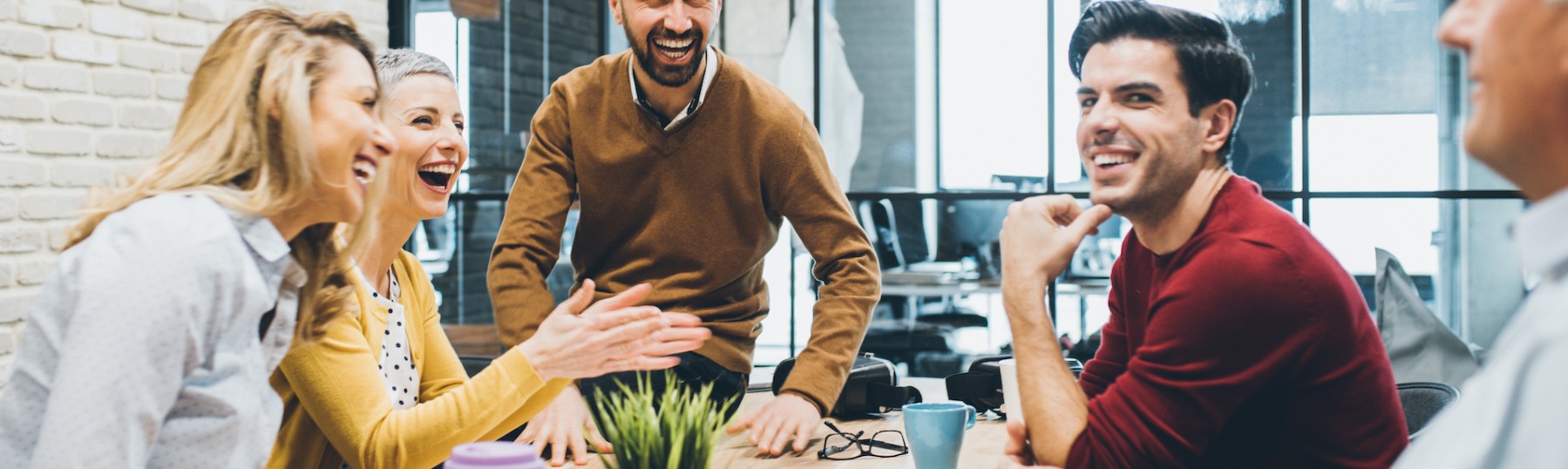 Cheerful business people laughing in office