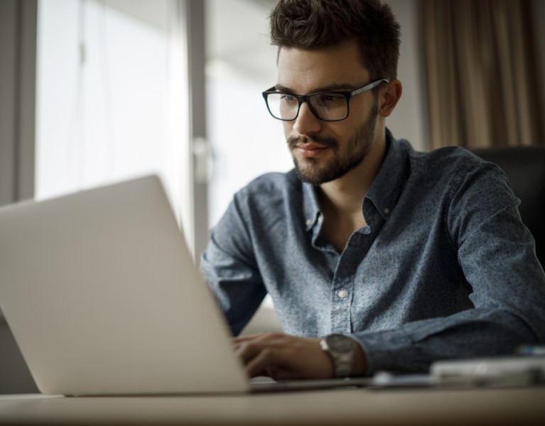 Young businessman working on laptop