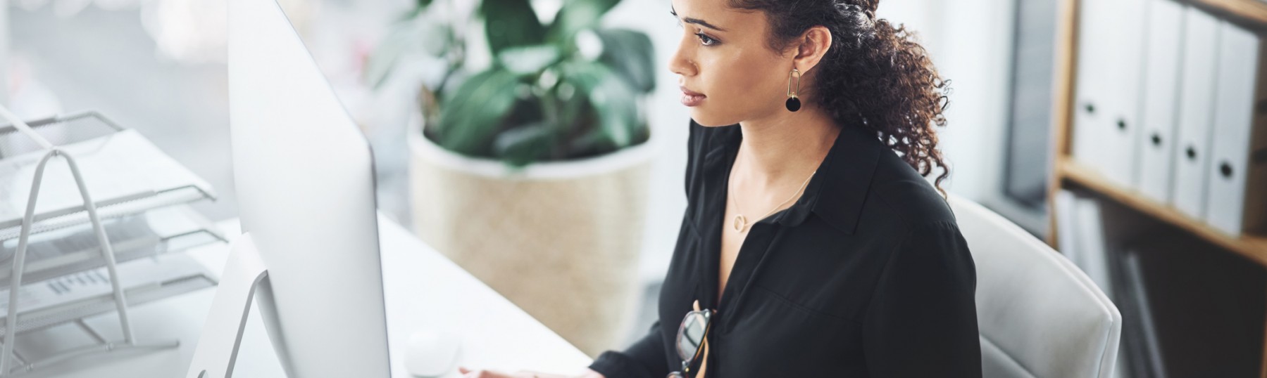 Shot of a young businesswoman working on a computer in an office