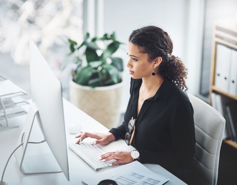 Shot of a young businesswoman working on a computer in an office